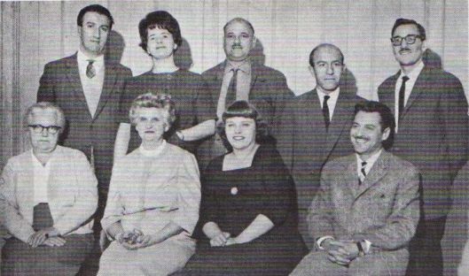 First National Spiritual Assembly of the Bahá’ís of Luxembourg, 1962-63. L to R, standing: Ronald Bates, Nancy Jordan, Ernest Claude Levy, Pierre Bram, Leslie Marcus Seated: Suzette Hipp, Honor Kempton, Betty Thompson, Faizollah Namdar