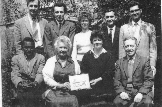 Spiritual Assembly of the Bahá’ís of Belfast (1959) Back Row: Charles Macdonald, Colin King, Sheila McCarthy, Rustam Jamshidi, Beman Khosravi. Front Row: Mustafa Sosseh (Gambia), Lisbeth Greeves, Yvonne Macdonald, Harry King