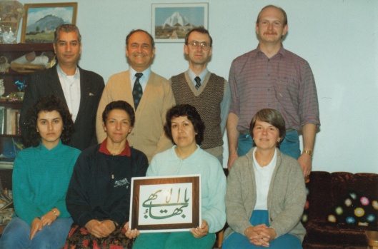 Spiritual Assembly of Omagh (August 1990) Back row: Nurullah Hedayati, Rustam Jamshidi, Malcolm Lake, Mark Gilmour Front row: Nooshin Hedayat, Vida Lake, Nadereh Hedayati, Rosemary Jamshidi
